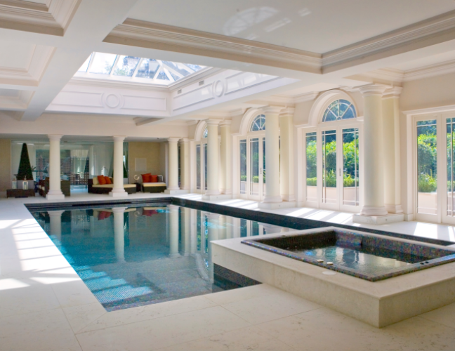 Luxury indoor geometric pool with a raised spa pool attached