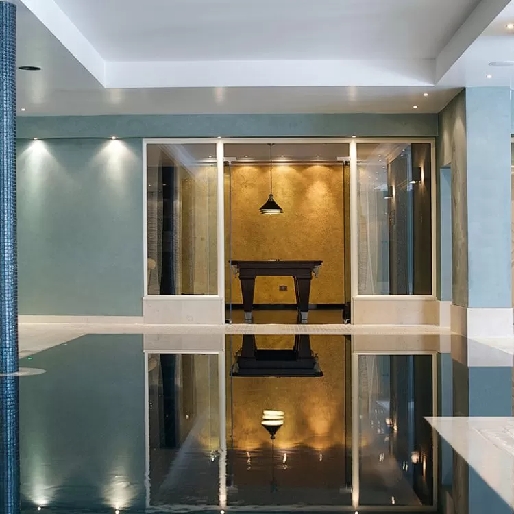 Indoor geometric pool with tiled pillars
