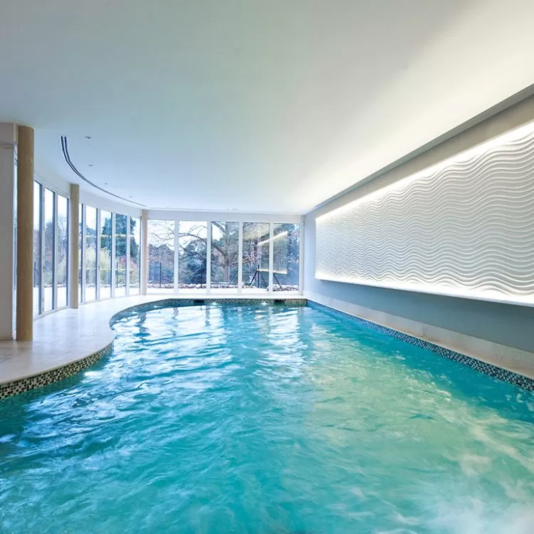 Indoor freeform pool with light feature wall