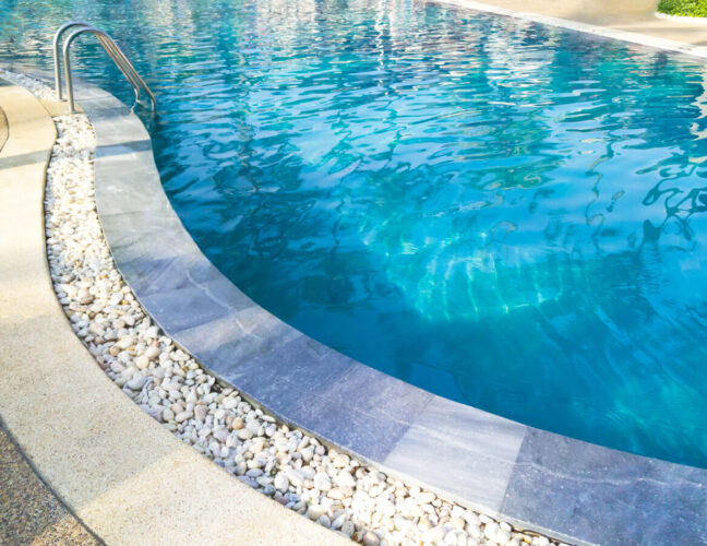 Falcon Pools freeform pool with pebble edge