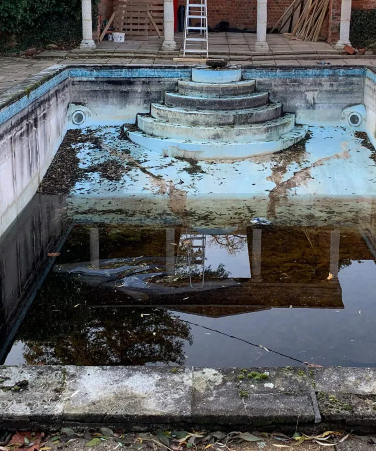 A dilapidated outdoor pool needing a refurbishment